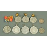 A small collection of Victoria Edwardian and George V white metal commemorative medallions,