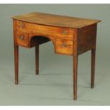 An early 19th century mahogany bowfronted dressing table,