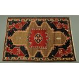 An Iranian fringed wool and cotton rug, principle colours blue, red and beige,