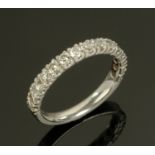 A platinum half eternity ring set with diamonds, size G/H.