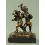 A 19th century bronze figure group of three playful putti,