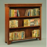 An Edwardian walnut open bookcase, with adjustable shelves and moulded pilasters.