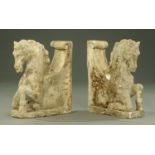 A pair of simulated sandstone gatepost or wall tops, in the form of prancing horses, height 69 cm.