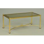 A rectangular brass coffee table, with smoked glass top. 106 cm x 51 cm.