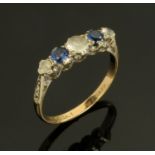A 9 ct gold and platinum mounted dress ring, set with clear and blue stones, size P.