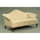 A Chippendale style settee, with arched back and rollover arms,