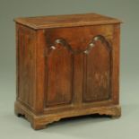 An antique oak coffer, narrow form, with two arched panels and raised on bracket feet. Width 72 cm.