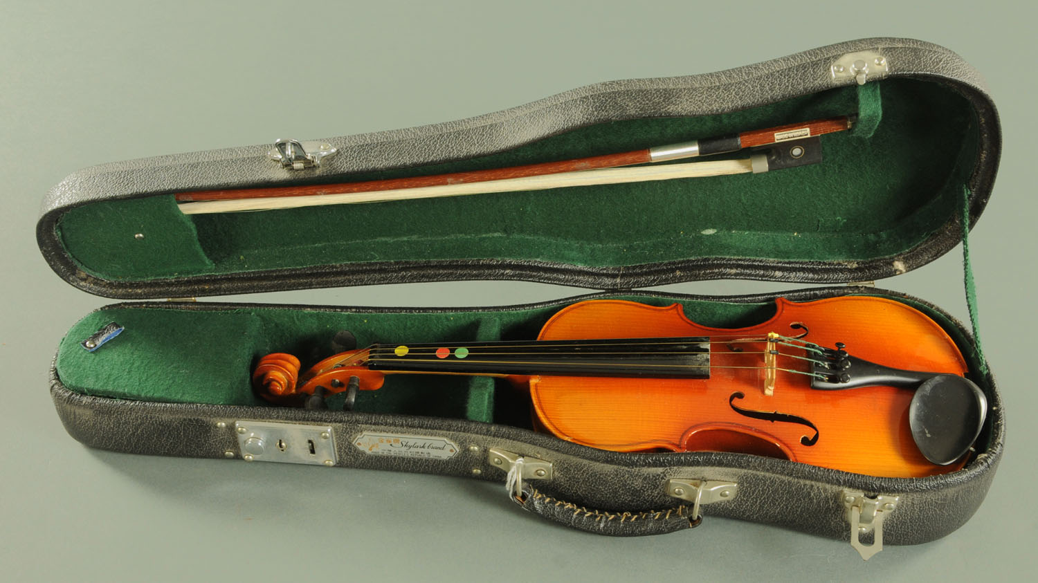 A Chinese 1/8 size violin, together with a 48.5 cm Korean bow, all within a Chinese hard shell case.