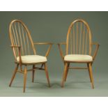 A pair of Ercol armchairs, each with loose cushion, bearing Ercol plaque to base.