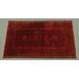 An Indian woollen rug, principal colours, red, black and beige,