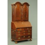 A Queen Anne double domed bureau bookcase, the upper section with adjustable shelves,