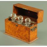 A late Victorian oak decanter casket, with three square form cut glass decanters. Width 38 cm.