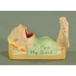 A novelty German bisque porcelain ashtray, early 20th century, modelled as a sleeping man,