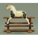 A small Edwardian trestle rocking horse, black and white painted.
