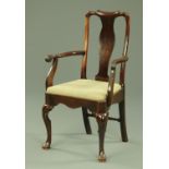 An 18th century chair, with later arms and raised on cabriole front legs terminating in pad feet.