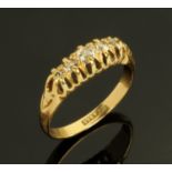 An 18 ct gold ring, set with five small diamonds, size J, 3.4 grams gross.