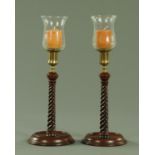 A good pair of turned mahogany and brass candlesticks, 19th century,