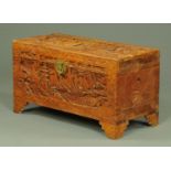 A Burmese carved camphorwood bedding box, intricately carved with figures,