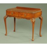 A walnut veneered desk, with rear upstand,