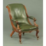 A Victorian mahogany open armchair, upholstered in green leather,