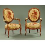 A pair of French walnut armchairs, with upholstered backs,