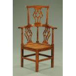 A George III oak Chippendale style corner armchair,