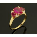 An 18 ct gold ruby and diamond ring, the central stone 10 mm x 6 mm, ring size S (see illustration).