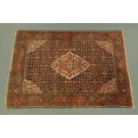 An Eastern rug, with centre rectangular panel with diamond shape motif to middle,