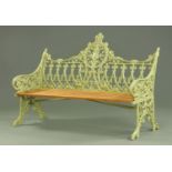 A Victorian style green painted metal garden bench, with slatted seat,