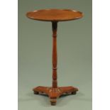 A Victorian mahogany occasional table, circular, with turned column and triform base.