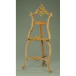 A French walnut easel bearing plaque J Cheret, in the Rococo style, width across platform 68 cm,