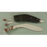 A Gurkha Kukri knife, in leather scabbard, with polished steel tip. Overall 45 cm.