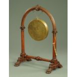 A Victorian gong frame, with reeded columns and downswept legs terminating in paw feet,