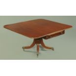 An early 19th century mahogany breakfast table, with twin drop flaps, frieze drawer to either end,
