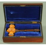 SS Pavonia, a carved and turned boxwood and simulated rosewood gavel, with silver plated ferrules,