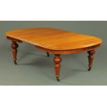 A Victorian mahogany wind out dining table, with leaf, with rounded ends and recessed frieze,