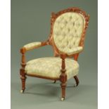 A Victorian walnut open armchair, with deep buttoned back, upholstered arms,
