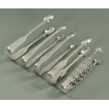 Five pairs of silver sugar tongs, various dates and makers,