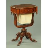 A Victorian rosewood sewing table, shaped outline, with frieze drawer, bag and cradle support,