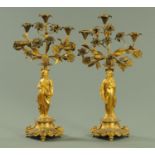 A pair of French patinated and gilt bronze figural five branch candelabra, 19th century,