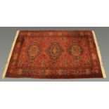 A Belgian wool Persian design fringed carpet,