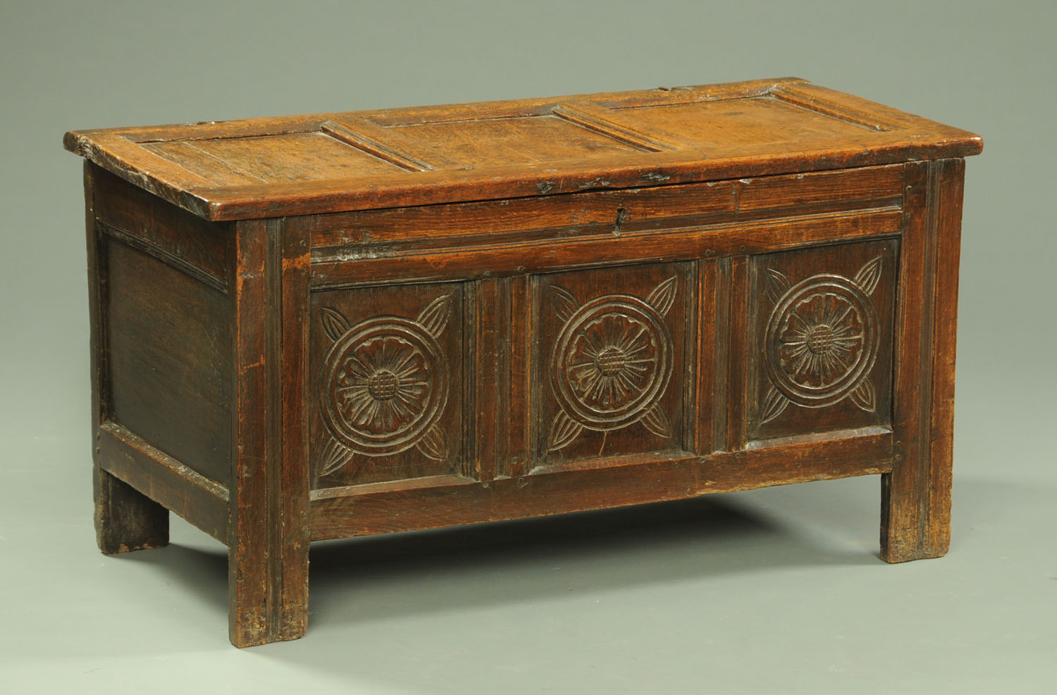 An 18th century oak coffer, three panelled,