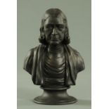 A Wedgwood black basalt bust of John Wesley, impressed marks, on a socle plinth. Height 21.5 cm.