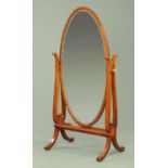 An Edwardian inlaid mahogany oval framed cheval mirror,