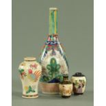 A Japanese polychrome enamel sake bottle, circa 1700, decorated with plants and flowers,