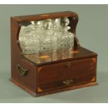 An Edwardian inlaid mahogany tantalus stand, with drawer fitted for cribbage, width 36 cm.