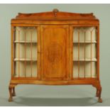 A 1930's well figured walnut serpentine fronted display case,