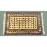 An Eastern fringed rug, with cockerel motif. 92 cm x 163 cm including fringe.