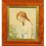 An early 19th century portrait of a young lady, half length looking left towards a rose bush,