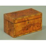 A 19th century walnut tea caddy, with two interior lidded compartments and with marquetry edge,